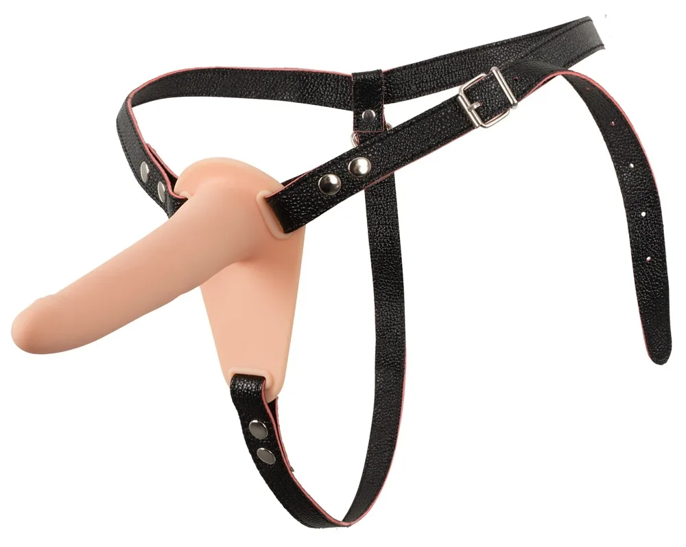 You2Toys Vibrating Strap-On sedd snett framifrån: ljus silikondildo på basplatta, monterad i svart justerbar sele med metallbeslag